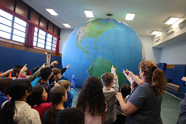 Classes at Gardiners Avenue Elementary School pointed out different territories on a giant globe brought to the school on Jan. 11.